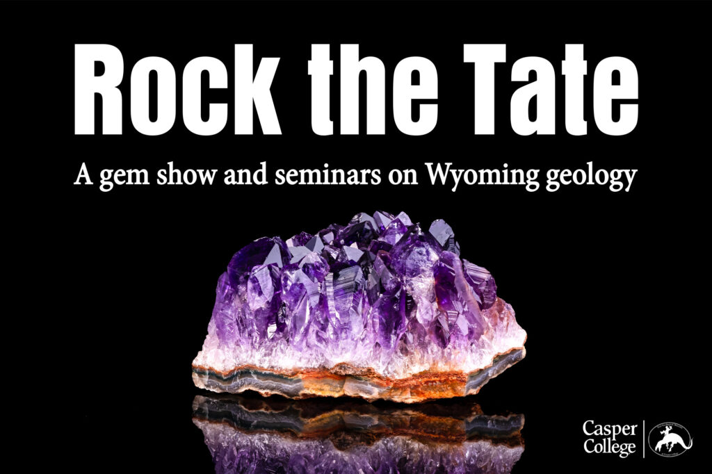 Large purple amethyst crystal cluster on a black reflective background for "Rock the Tate," a gem show and Wyoming geology seminar event at Casper College.
